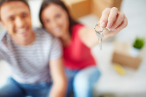 Couple holding up new house keys